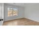 Bright bedroom with hardwood floors, large window, and white trim, offering a serene space at 704 N Godfrey Park Pl, Charleston, SC 29407