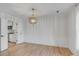 Bright dining room boasts wood floors, wainscoting, and stylish chandelier at 704 N Godfrey Park Pl, Charleston, SC 29407