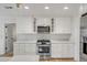 Beautiful kitchen with white cabinets, stainless steel appliances, and quartz countertops at 704 N Godfrey Park Pl, Charleston, SC 29407