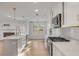 Spacious kitchen featuring a large island, white cabinets, and stainless steel appliances at 704 N Godfrey Park Pl, Charleston, SC 29407
