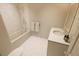 Bright bathroom featuring white marble tile, a bathtub, shower, and single sink vanity at 7614 Indigo Palms Way, Johns Island, SC 29455