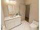 Bathroom featuring tiled floors, a single sink vanity, toilet, and an open doorway to the next room at 7614 Indigo Palms Way, Johns Island, SC 29455