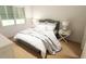 Cozy bedroom featuring a queen-size bed, window with shutters, and hardwood floors at 7614 Indigo Palms Way, Johns Island, SC 29455