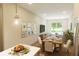 Dining room with view of the living room, hardwood floors, and a dining room table with seating for four at 7614 Indigo Palms Way, Johns Island, SC 29455