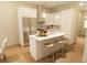Bright kitchen with stainless steel refrigerator and a spacious island with barstool seating at 7614 Indigo Palms Way, Johns Island, SC 29455