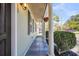 Charming porch featuring slate flooring, white columns, and hanging plants, adding curb appeal at 817 Savage Rd, Charleston, SC 29407