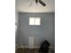 Empty bedroom with pale blue walls, featuring a window and space for customization at 90 Romney St, Charleston, SC 29403