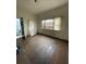 Bright living room featuring hardwood floors, a window with blinds, and plenty of natural light at 90 Romney St, Charleston, SC 29403