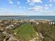 Expansive aerial view of a picturesque community featuring a golf course, homes, and sparkling water at 9002 Palmetto Drive #514 1/13 Share, Isle of Palms, SC 29451
