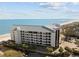 Beautiful exterior view of a condominium complex near a white sand beach with black balcony railings on each unit at 9002 Palmetto Drive #514 1/13 Share, Isle of Palms, SC 29451