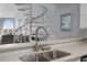 Kitchen featuring granite countertops, stainless steel sink, with a glimpse of the living area and spiral staircase at 9002 Palmetto Drive #514 1/13 Share, Isle of Palms, SC 29451