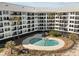 A lovely pool is surrounded by palm trees and multiple balconies in this beachfront condominium complex at 9002 Palmetto Drive #514 1/13 Share, Isle of Palms, SC 29451