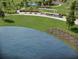 An aerial view of a community park featuring walking trails, seating, and a lake at 915 Dusk Dr, Summerville, SC 29486