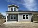 New construction home with gray siding, covered porch, and modern windows at 915 Dusk Dr, Summerville, SC 29486