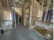 The interior framing of a new home showcases the wood framework, future shower stall, door openings and staircase at 915 Dusk Dr, Summerville, SC 29486