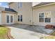 Backyard patio with concrete slab and brick trim, connecting to the home via glass doors at 9620 Pebble Creek Blvd, Summerville, SC 29485