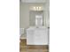 Bathroom featuring a well-lit vanity with white cabinets and hard surface counters, adjacent to the toilet at 9620 Pebble Creek Blvd, Summerville, SC 29485