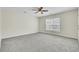 Spacious bedroom with a ceiling fan, large window, and neutral carpet, perfect for relaxation at 9620 Pebble Creek Blvd, Summerville, SC 29485