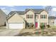 Charming two-story home boasts a well-maintained front yard and a two car garage at 9620 Pebble Creek Blvd, Summerville, SC 29485