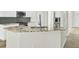 Kitchen island features stone countertops and a stainless steel faucet at 9620 Pebble Creek Blvd, Summerville, SC 29485