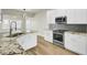 Modern kitchen features granite counters, stainless appliances, and a gray tile backsplash at 9620 Pebble Creek Blvd, Summerville, SC 29485