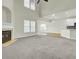 Spacious living room featuring a fireplace, plush carpet, and lots of natural light at 9620 Pebble Creek Blvd, Summerville, SC 29485