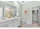 Well-lit bathroom features double sinks, neutral tiling, and a walk-in closet at 103 Pen Shell St, Summerville, SC 29485