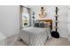 Nautical themed bedroom with soft natural light, neutral bedding, and shelves featuring marine decor at 103 Pen Shell St, Summerville, SC 29485