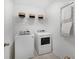 Functional laundry room equipped with modern washer, dryer, and storage shelves for convenience at 103 Pen Shell St, Summerville, SC 29485