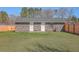 Brick home backyard featuring green grass, trees, and a privacy fence at 104 Ashdown Dr, Summerville, SC 29483