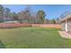Backyard featuring green grass, trees, and a tall privacy fence at 104 Ashdown Dr, Summerville, SC 29483