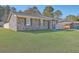 A well-maintained single-story brick house with a lush green lawn at 104 Ashdown Dr, Summerville, SC 29483