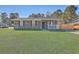 Charming brick ranch-style home with a well-manicured lawn and a cozy front porch at 104 Ashdown Dr, Summerville, SC 29483
