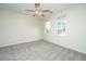 Spacious bedroom featuring plush carpet, a ceiling fan, and natural light from two windows at 1225 Blakeway St # 406, Charleston, SC 29492