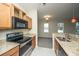 Modern kitchen with granite countertops, a stainless steel oven, and shaker style cabinetry at 1225 Blakeway St # 406, Charleston, SC 29492