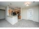 Modern kitchen featuring wood cabinets, stainless steel appliances, a breakfast bar, and an adjacent living space at 1225 Blakeway St # 406, Charleston, SC 29492