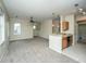 Spacious living area with carpet, ceiling fan, and a view of the kitchen with stainless steel appliances at 1225 Blakeway St # 406, Charleston, SC 29492