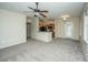 Open living space with carpet, ceiling fan, and kitchen featuring stainless steel appliances and breakfast bar at 1225 Blakeway St # 406, Charleston, SC 29492