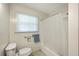 Bright bathroom with a shower-tub combo, white fixtures, and a window for natural light at 1228 Hawthorne Rd, Hanahan, SC 29410