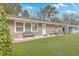 Inviting brick home featuring a cozy front porch and a beautifully landscaped yard at 1228 Hawthorne Rd, Hanahan, SC 29410