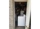 Small laundry area with a top-load washing machine, water heater, and storage shelves seen from doorway at 1228 Hawthorne Rd, Hanahan, SC 29410