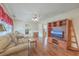Cozy living room featuring hardwood floors, a comfortable sofa, and an entertainment center at 1228 Hawthorne Rd, Hanahan, SC 29410