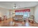 Inviting living room featuring hardwood floors, a plush sofa, and a ceiling fan at 1228 Hawthorne Rd, Hanahan, SC 29410