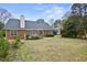 Spacious backyard featuring a lush lawn and a brick house at 1354 Old Ivy Way, Mount Pleasant, SC 29466