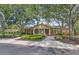 Stately brick home with a circular driveway, well-manicured landscaping, and mature trees at 1354 Old Ivy Way, Mount Pleasant, SC 29466