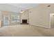 Light-filled living room featuring plush carpeting, a brick fireplace, and a sliding door to the backyard at 1354 Old Ivy Way, Mount Pleasant, SC 29466