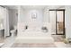 Bathroom showcases a soaking tub with white tile surround, glass enclosed shower, and herringbone pattern accent wall at 1401 Cooper River Blvd, Moncks Corner, SC 29461