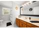 Bathroom featuring wood cabinets, a white countertop, modern fixtures, and ample natural light from a window at 1401 Cooper River Blvd, Moncks Corner, SC 29461
