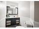 Bathroom featuring a dark vanity with modern fixtures, decorative mirror, and wainscoting at 1401 Cooper River Blvd, Moncks Corner, SC 29461