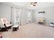 Bedroom featuring a glider chair, a changing table, and natural light creating a comforting and nurturing space at 1401 Cooper River Blvd, Moncks Corner, SC 29461